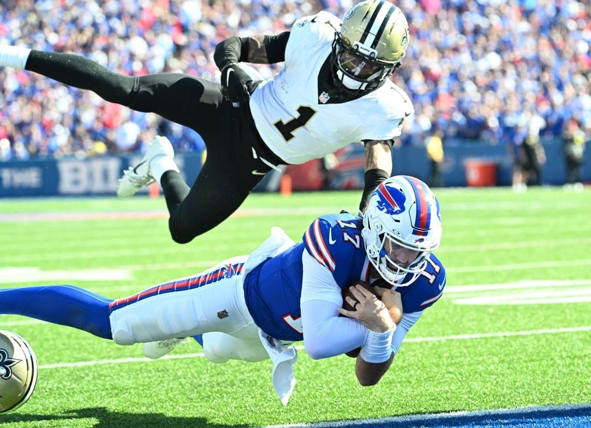 Sep 28, 2025; Orchard Park, New York, USA;  Buffalo Bills quarterback Josh Allen (17) dives for a touchdown past New Orleans Saints cornerback Alontae Taylor (1) during the third quarter at Highmark Stadium. Mandatory Credit: Mark Konezny-Imagn Images