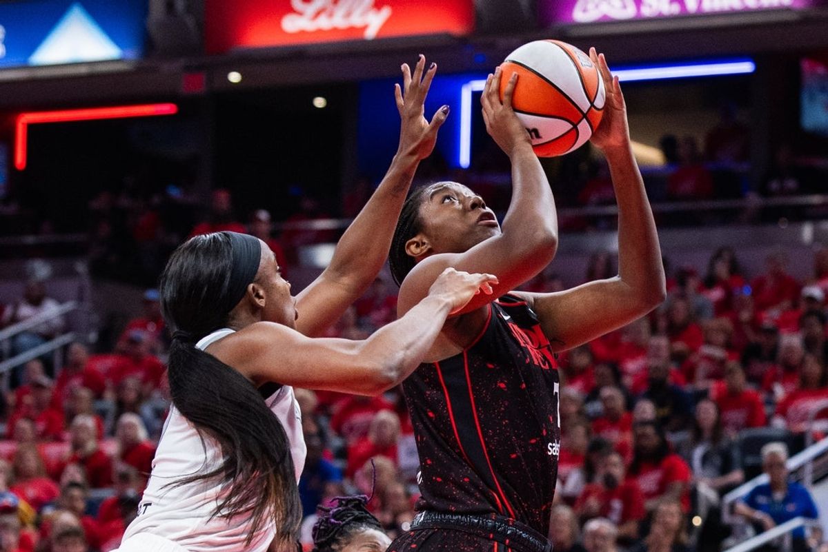 Sep 28, 2025; Indianapolis, Indiana, USA; Indiana Fever forward Aliyah Boston (7) shoots the ball while Las Vegas Aces guard Jackie Young (0) defends in the first half during game four of the second round for the 2025 WNBA Playoffs at Gainbridge Fieldhouse. Mandatory Credit: Trevor Ruszkowski-Imagn Images