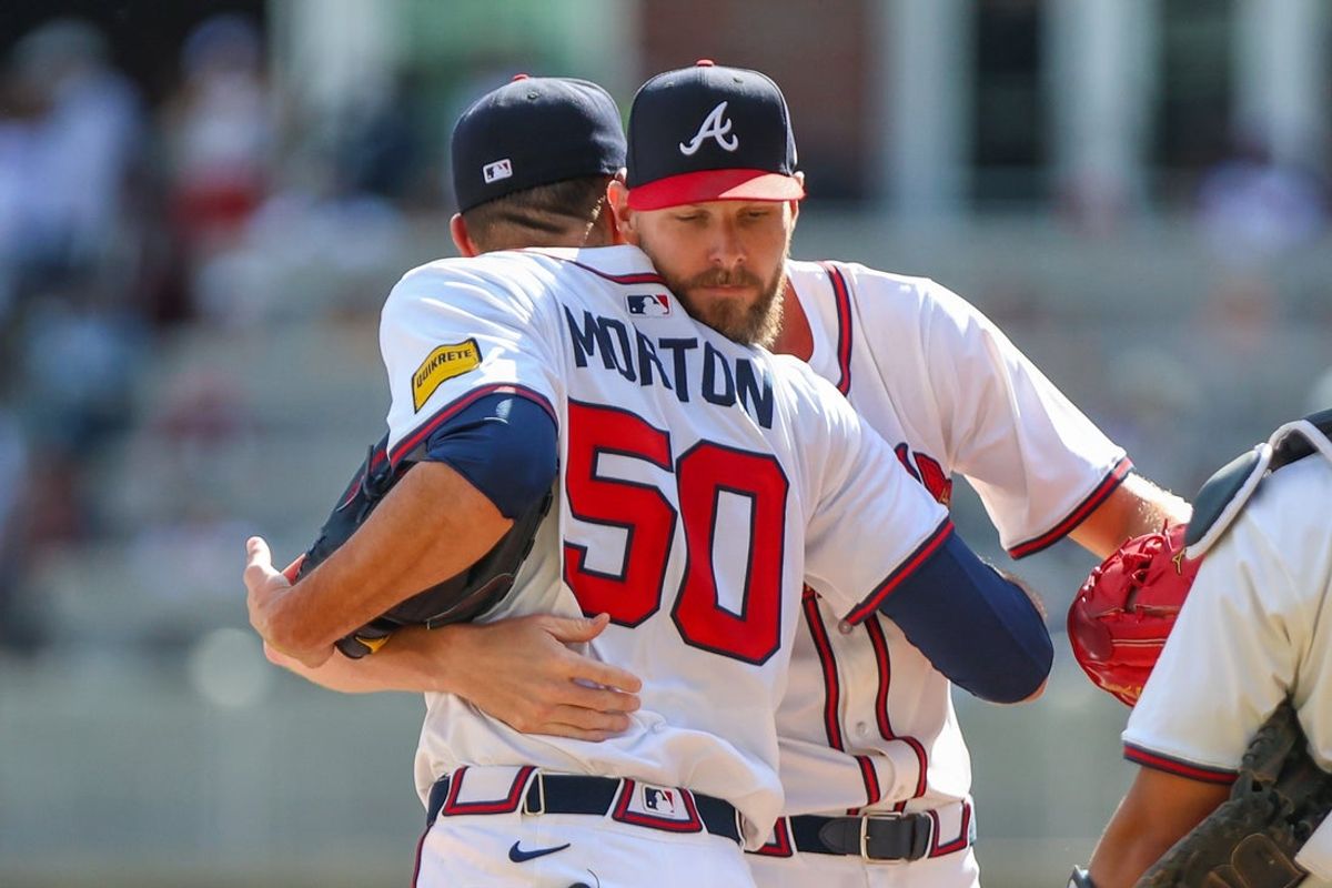 Sep 28, 2025; Cumberland, Georgia, USA; Atlanta Braves pitcher Charlie Morton (50) hugs teammate pitcher Chris Sale (51) after pitching against the Pittsburgh Pirates during the second inning at Truist Park. Mandatory Credit: Jordan Godfree-Imagn Images