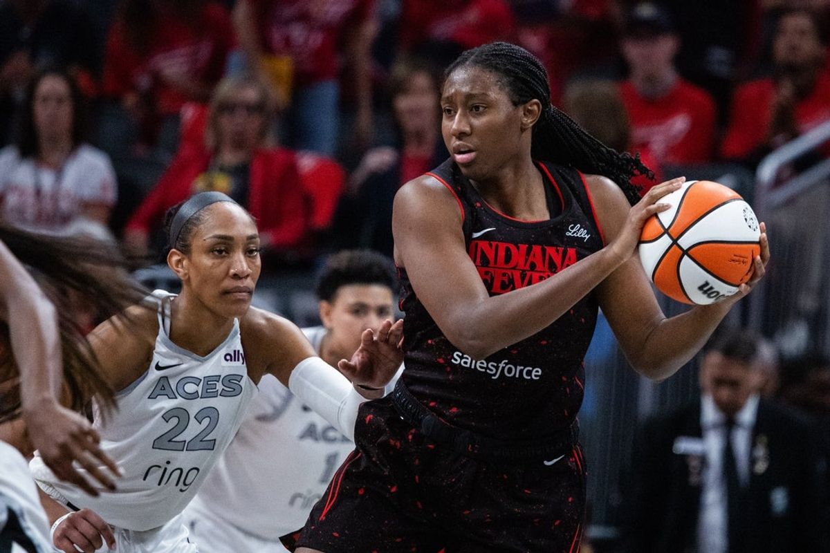 Sep 28, 2025; Indianapolis, Indiana, USA; Indiana Fever forward Aliyah Boston (7) holds the ball while Las Vegas Aces center A'ja Wilson (22) defends in the second half  during game four of the second round for the 2025 WNBA Playoffs at Gainbridge Fieldhouse. Mandatory Credit: Trevor Ruszkowski-Imagn Images