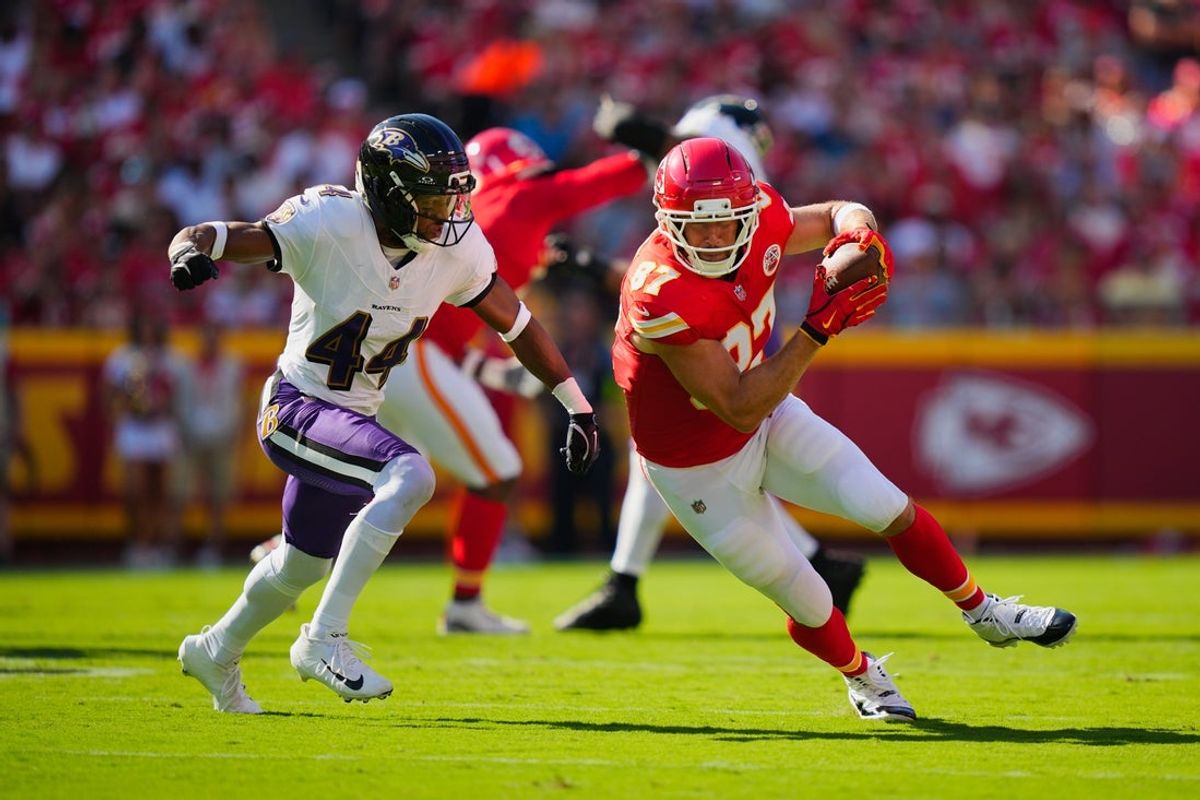 Sep 28, 2025; Kansas City, Missouri, USA; Kansas City Chiefs tight end Travis Kelce (87) rushes as Baltimore Ravens cornerback Marlon Humphrey (44) defends during the first half at GEHA Field at Arrowhead Stadium. Mandatory Credit: Jay Biggerstaff-Imagn Images