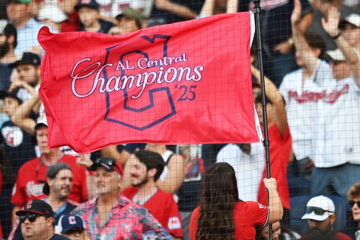 Sep 28, 2025; Cleveland, Ohio, USA;  A member of the Cleveland Strikers waves an American League Central Division champions flag during the game between the Cleveland Guardians and the Texas Rangers at Progressive Field. Mandatory Credit: Ken Blaze-Imagn Images