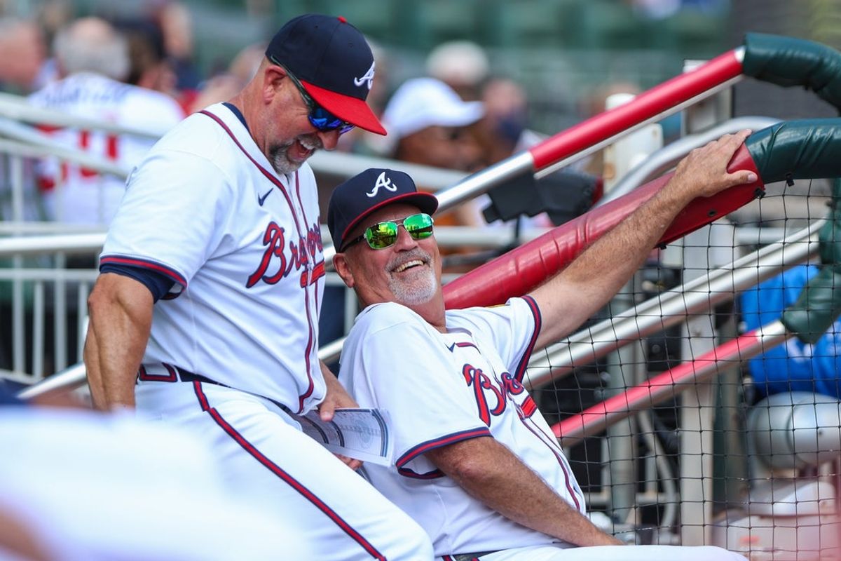 Sep 28, 2025; Cumberland, Georgia, USA; Atlanta Braves bench coach/infield coach Walt Weiss (4) and manager Brian Snitker (43) laugh in the dugout during the game against the Pittsburgh Pirates during the third inning at Truist Park. Mandatory Credit: Jordan Godfree-Imagn Images