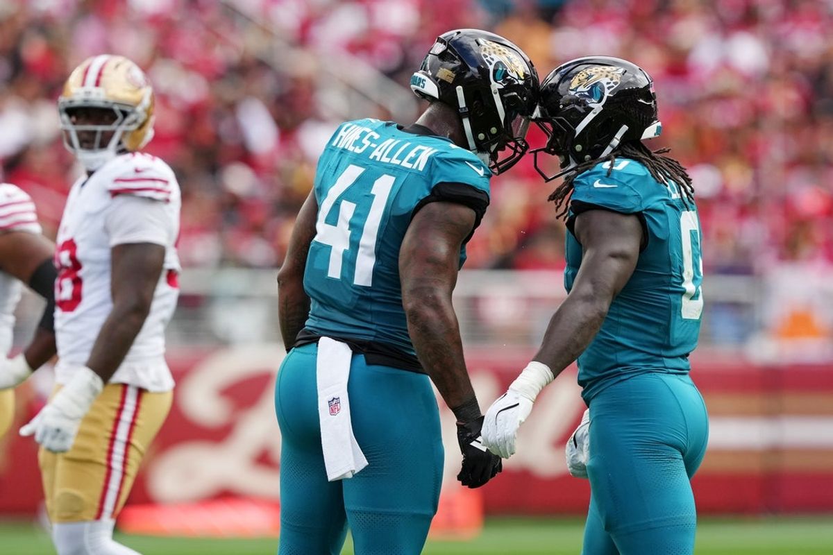 Sep 28, 2025; Santa Clara, California, USA; Jacksonville Jaguars running back Travis Etienne Jr. (1) celebrates after scoring a touchdown with Jacksonville Jaguars defensive end Josh Hines-Allen (41) during the second half against the San Francisco 49ers at Levi's Stadium. Mandatory Credit: Darren Yamashita-Imagn Images