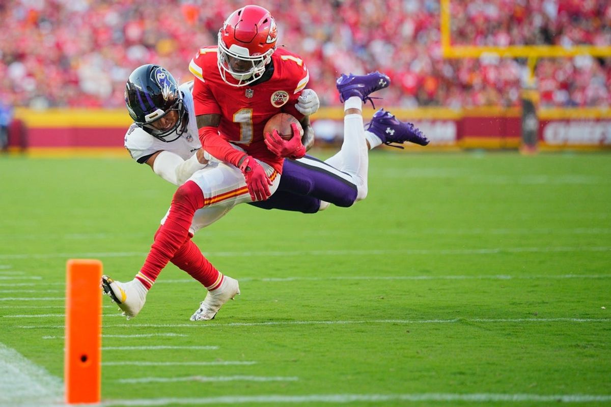 Sep 28, 2025; Kansas City, Missouri, USA;  Kansas City Chiefs wide receiver Xavier Worthy (1) runs after making a catch as Baltimore Ravens cornerback Marlon Humphrey (44) defends during the third quarter at GEHA Field at Arrowhead Stadium. Mandatory Credit: Jay Biggerstaff-Imagn Images