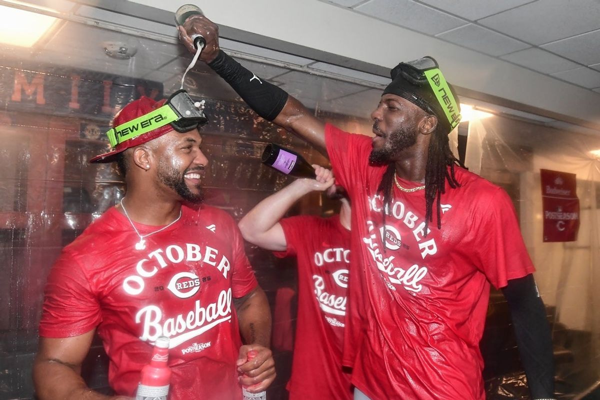Sep 28, 2025; Milwaukee, Wisconsin, USA;  Cincinnati Reds shortstop Elly De La Cruz (right) celebrates after the Reds clinched a wild card spot after the game against the Milwaukee Brewers at American Family Field. Mandatory Credit: Benny Sieu-Imagn Images