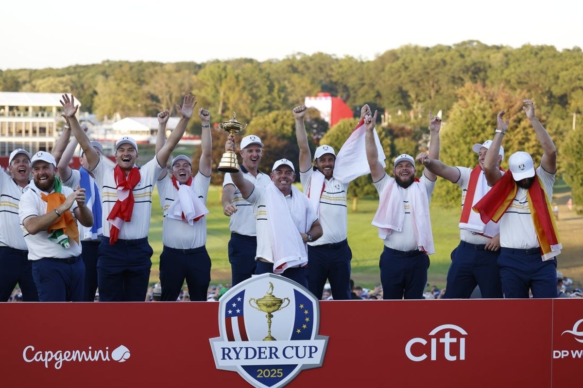 Sep 28, 2025; Bethpage, New York, USA;  Team Europe golfer Rory McIlroy reacts with the trophy after defeating Team USA on the final day of competition for the Ryder Cup at Bethpage Black. Mandatory Credit: Peter Casey-Imagn Images