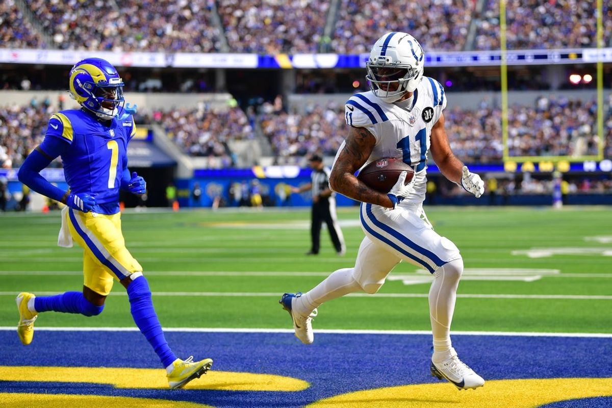 Sep 28, 2025; Inglewood, California, USA; Indianapolis Colts wide receiver Michael Pittman (11) scores a touchdown ahead of Los Angeles Rams cornerback Emmanuel Forbes Jr. (1) during the second half at SoFi Stadium. Mandatory Credit: Gary A. Vasquez-Imagn Images