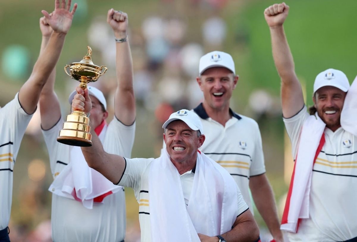 [US, Mexico & Canada customers only] Sep 28, 2025; Bethpage, New York, USA; Team Europe's Rory McIlroy celebrates with the trophy after winning the Ryder Cup as Tommy Fleetwood and Justin Rose look on the final day of competition for the Ryder Cup at Bethpage Black. Mandatory Credit: Paul Childs-Reuters via Imagn Images