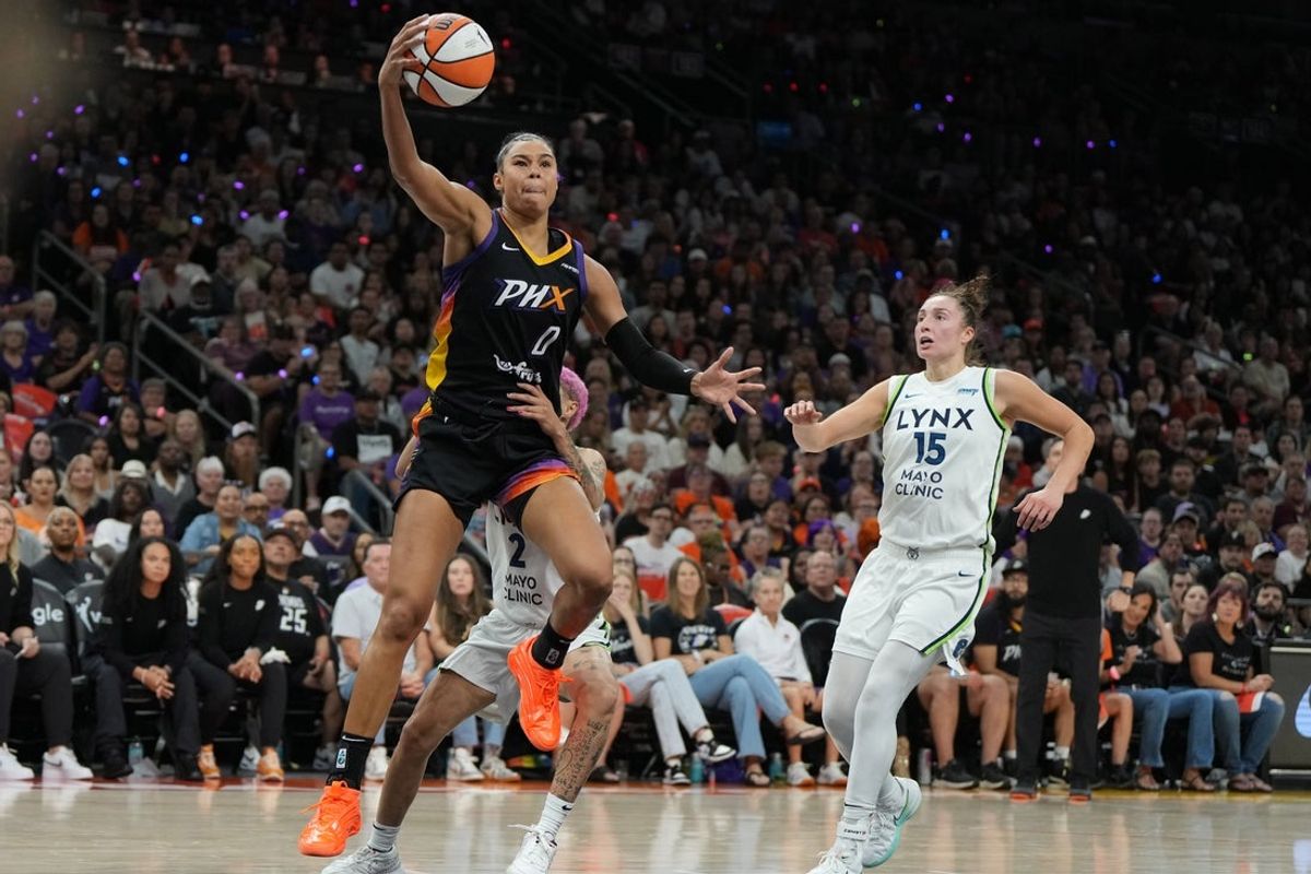 Sep 28, 2025; Phoenix, Arizona, USA; Phoenix Mercury forward Satou Sabally (0) drives past Minnesota Lynx guard Natisha Hiedeman (2) and forward Jessica Shepard (15) in the first half during game four of the second round for the 2025 WNBA Playoffs at PHX Arena. Mandatory Credit: Rick Scuteri-Imagn Images