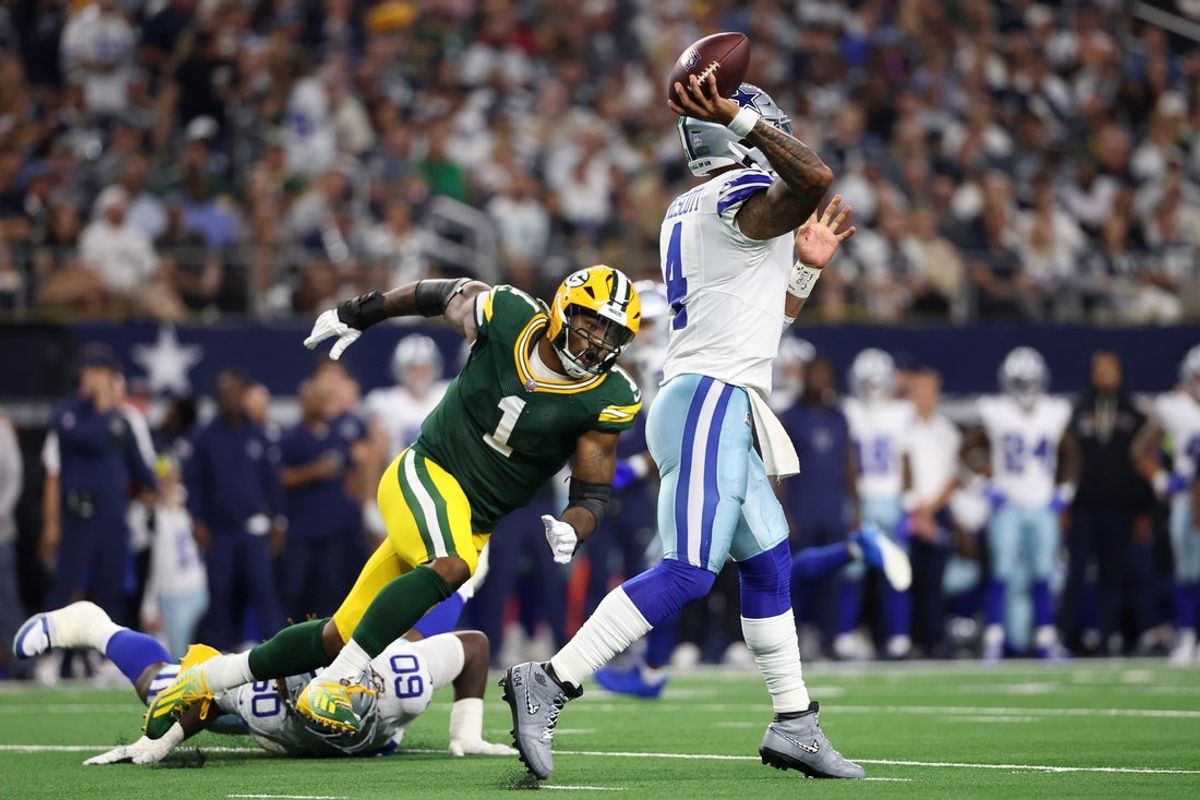 Sep 28, 2025; Arlington, Texas, USA; Dallas Cowboys quarterback Dak Prescott (4) throws under pressure from Green Bay Packers defensive end Micah Parsons (1) in the first quarter at AT&T Stadium. Mandatory Credit: Kevin Jairaj-Imagn Images