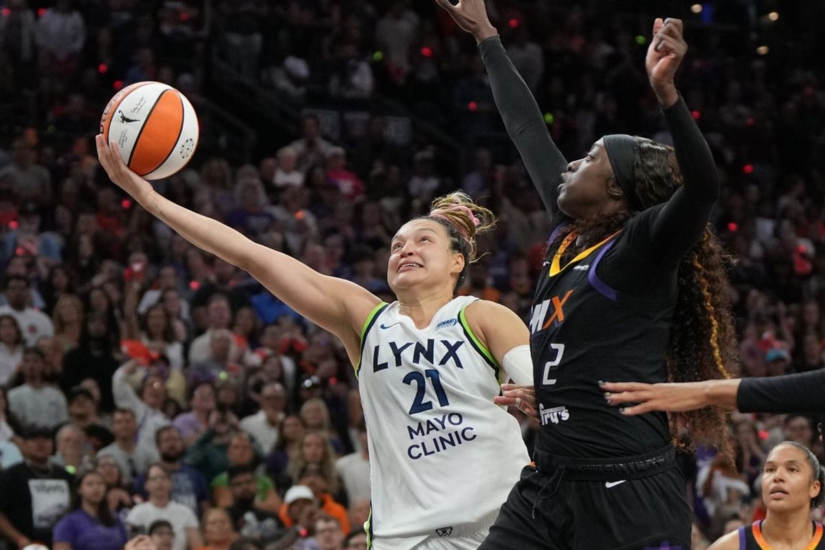 Sep 28, 2025; Phoenix, Arizona, USA; Minnesota Lynx guard Kayla McBride (21) shoots on Phoenix Mercury guard Kahleah Copper (2) in the second half during game four of the second round for the 2025 WNBA Playoffs at PHX Arena. Mandatory Credit: Rick Scuteri-Imagn Images