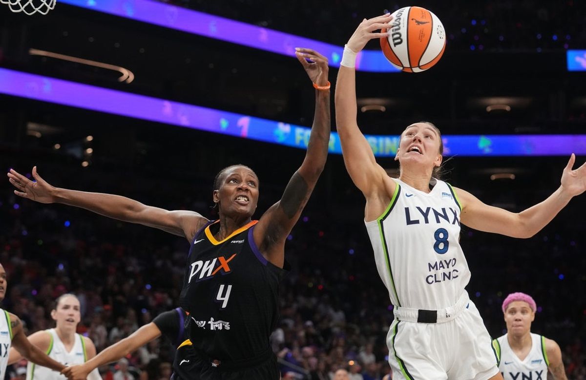 Phoenix Mercury forward Natasha Mack (4) fights for a rebound with Minnesota Lynx forward Alanna Smith (8) during their WNBA semifinal playoff game at PHX Arena on Sept. 28, 2025.