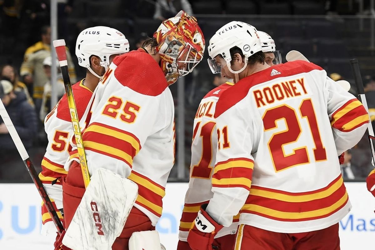 Feb 6, 2024; Boston, Massachusetts, USA; Calgary Flames goaltender Jacob Markstrom (25) and center Kevin Rooney (21) butt heads after defeating the Boston Bruins at TD Garden.