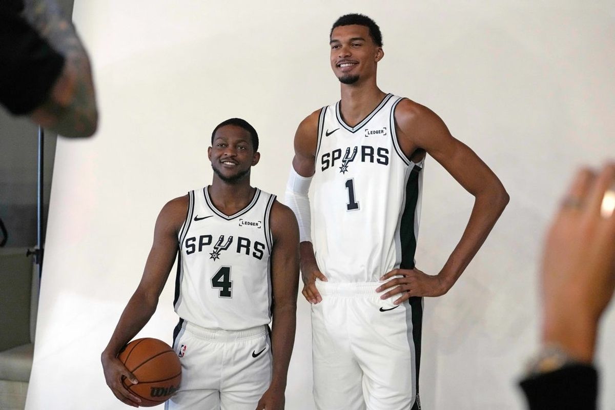 Sep 29, 2025; San Antonio, TX, USA; San Antonio Spurs forward-center Victor Wembanyama (1) and guard De’Aaron Fox (4) pose for photos during Media Day at Victory Capital Performance Center in San Antonio. Mandatory Credit: Scott Wachter-Imagn Images