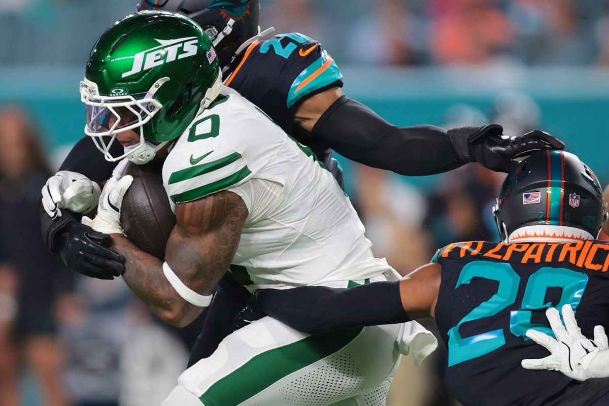 Sep 29, 2025; Miami Gardens, Florida, USA; New York Jets running back Braelon Allen (0) rushes the ball against Miami Dolphins defensive back Elijah Campbell (22) during the first half at Hard Rock Stadium. Mandatory Credit: Sam Navarro-Imagn Images