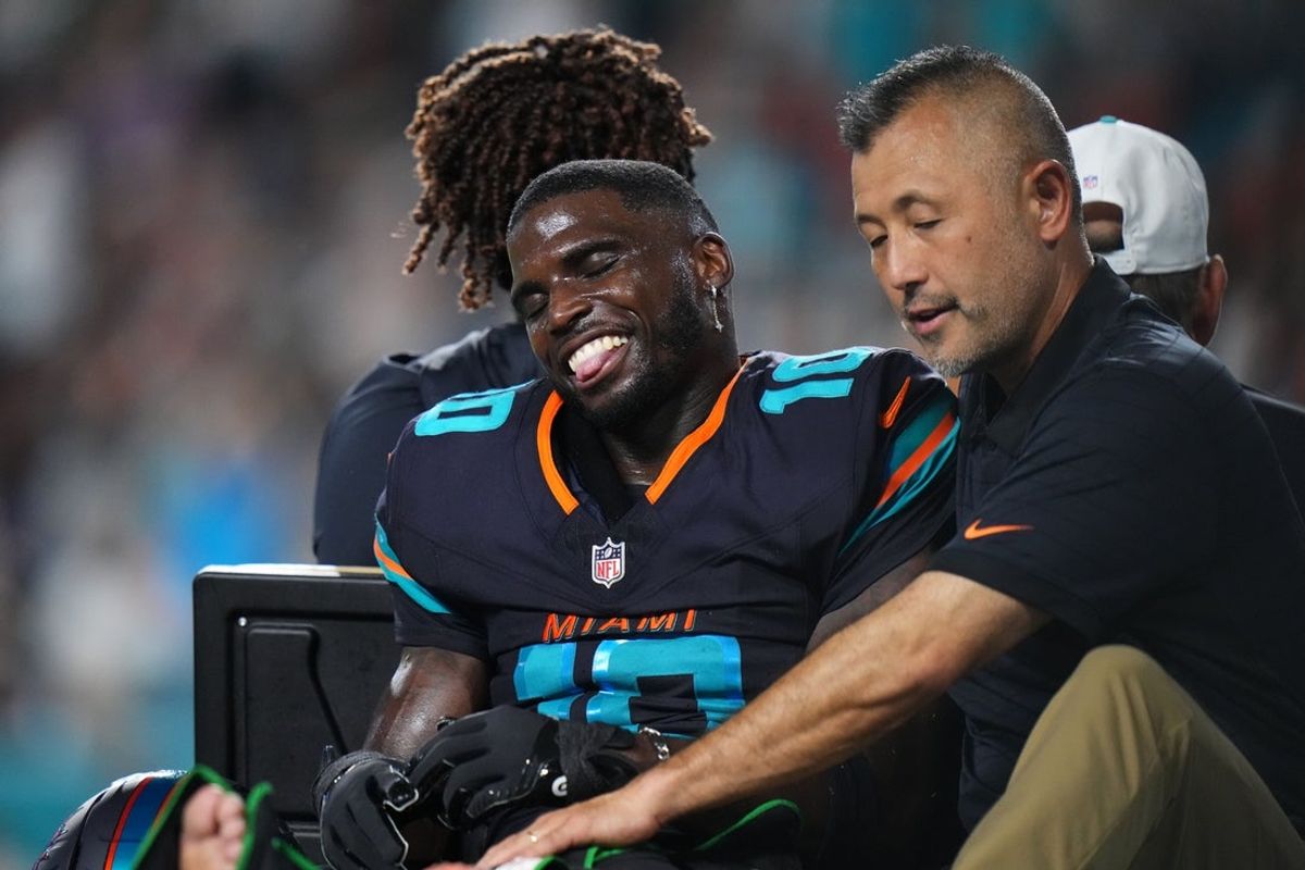 Sep 29, 2025; Miami Gardens, Florida, USA; Miami Dolphins wide receiver Tyreek Hill (10) is tended to by medical staff after injuring his leg against the New York Jets during the second half at Hard Rock Stadium. Mandatory Credit: Rich Storry-Imagn Images