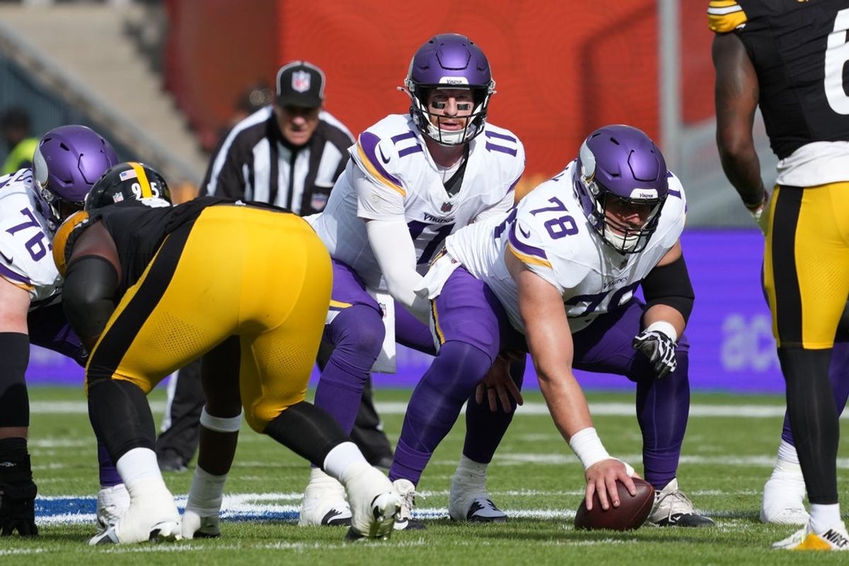 Sep 28, 2025; Dublin, Ireland;  Minnesota Vikings quarterback Carson Wentz (11) takes the snap from center Ryan Kelly (78) in the first half against the Pittsburgh Steelers during an NFL International Series game at Croke Park. Mandatory Credit: Kirby Lee-Imagn Images