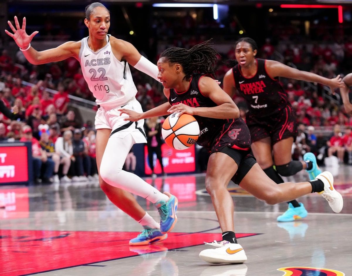Las Vegas Aces center A'ja Wilson (22) defends Indiana Fever guard Kelsey Mitchell (0) during Game 4 of the WNBA semifinals on Sunday, Sept. 28, 2025, at Gainbridge Fieldhouse in Indianapolis. The Fever defeated the Aces 90-83.