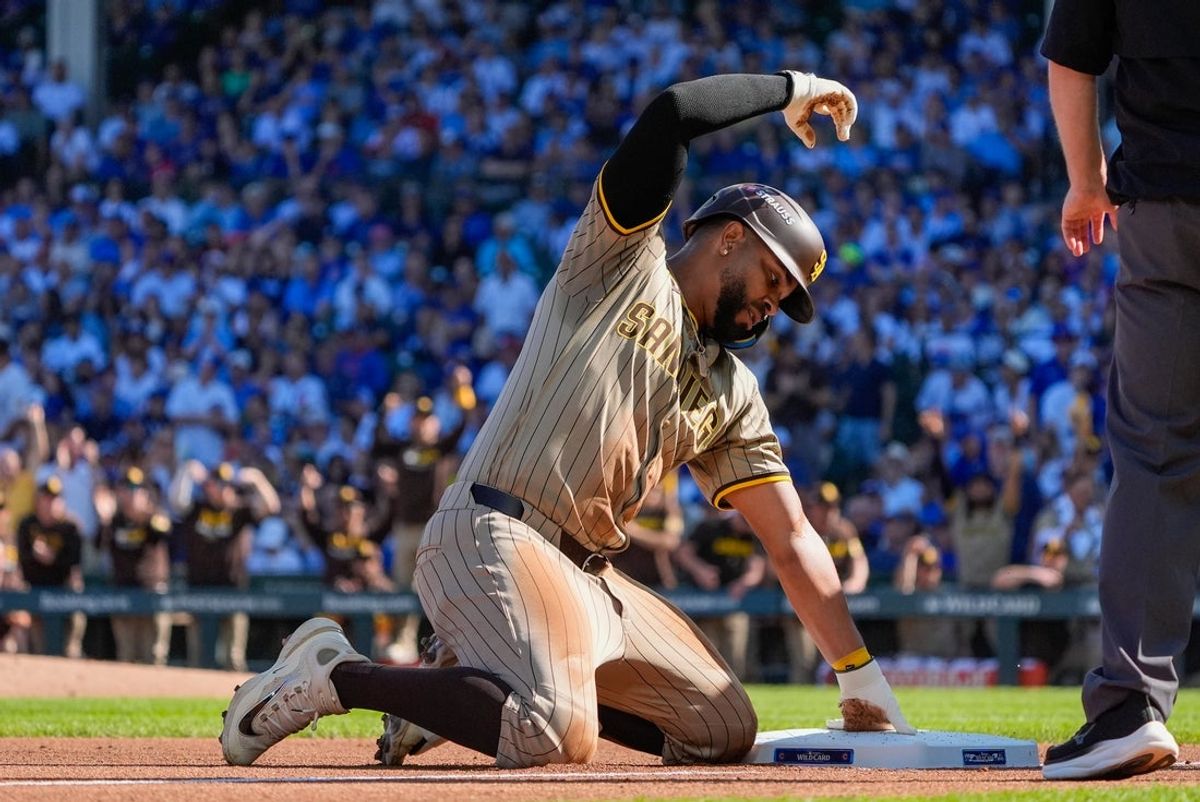 Sep 30, 2025; Chicago, Illinois, USA; San Diego Padres shortstop Xander Bogaerts (2) slides safely into third base after a throwing error made by the Chicago Cubs in the second inning during game one of the Wildcard round for the 2025 MLB playoffs at Wrigley Field. Mandatory Credit: David Banks-Imagn Images
