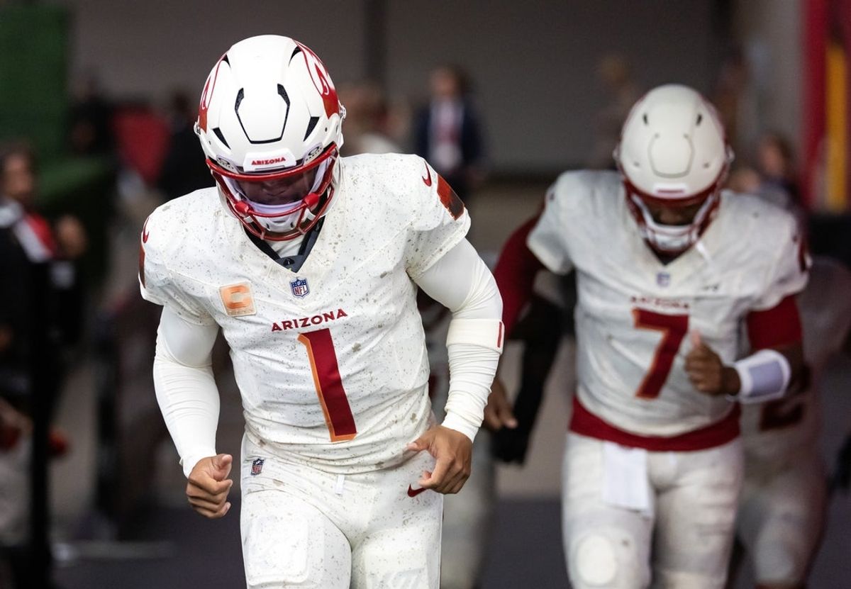 Sep 25, 2025; Glendale, Arizona, USA; Arizona Cardinals quarterback Kyler Murray (1) and Jacoby Brissett (7) against the Seattle Seahawks at State Farm Stadium. Mandatory Credit: Mark J. Rebilas-Imagn Images