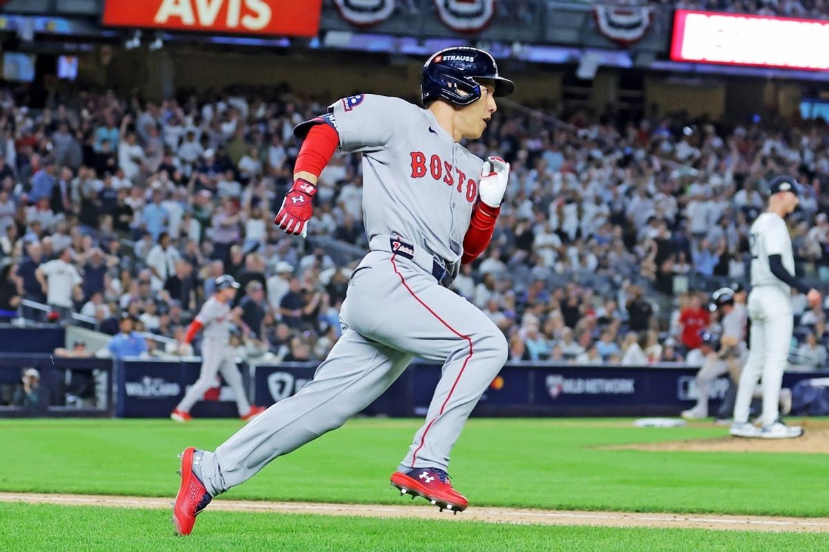 Sep 30, 2025; Bronx, New York, USA; Boston Red Sox outfielder Masataka Yoshida (7) hits a two run RBI during the seventh inning against the New York Yankees during game one of the Wildcard round for the 2025 MLB playoffs at Yankee Stadium. Mandatory Credit: Brad Penner-Imagn Images
