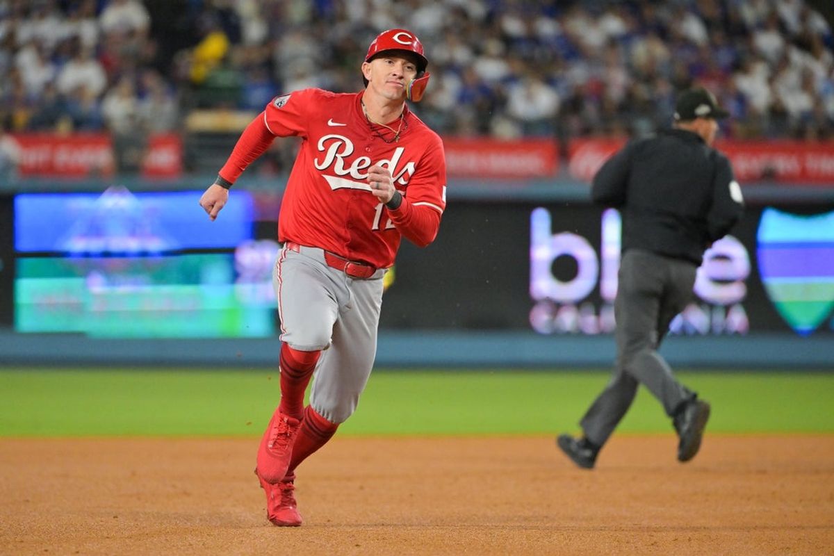 Sep 30, 2025; Los Angeles, California, USA; Cincinnati Reds left fielder Austin Hays (12) advances to third base on a single from Cincinnati Reds first baseman Spencer Steer (7) (not pictured) during the seventh inning against the Los Angeles Dodgers during game one of the Wildcard round for the 2025 MLB playoffs at Dodger Stadium. Mandatory Credit: Jayne Kamin-Oncea-Imagn Images
