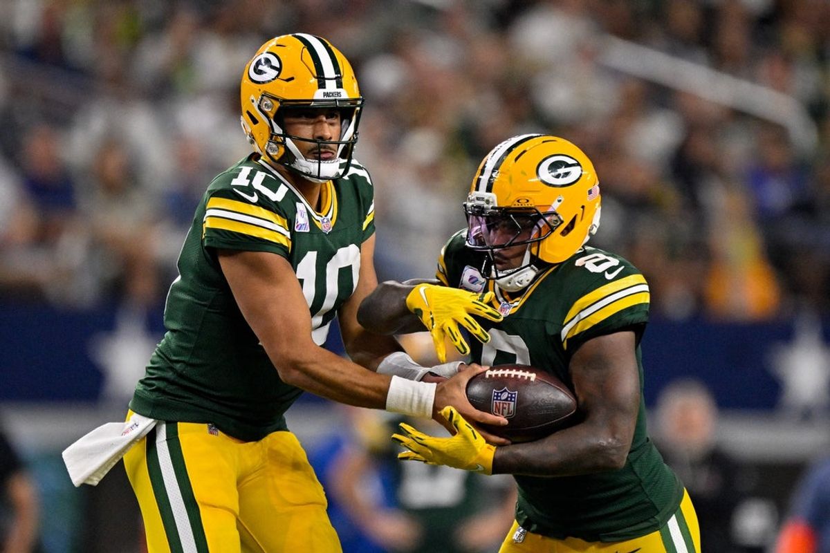 Sep 28, 2025; Arlington, Texas, USA; Green Bay Packers quarterback Jordan Love (10) hands the ball off to running back Josh Jacobs (8) during the game between the Dallas Cowboys and the Green Bay Packers at AT&T Stadium. Mandatory Credit: Jerome Miron-Imagn Images