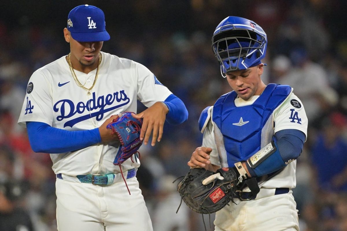 Sep 30, 2025; Los Angeles, California, USA; Los Angeles Dodgers relief pitcher Edgardo Henriquez (60) and Los Angeles Dodgers catcher Ben Rortvedt (47) look on after walking home a run during the eighth inning against the Cincinnati Reds during game one of the Wildcard round for the 2025 MLB playoffs at Dodger Stadium. Mandatory Credit: Jayne Kamin-Oncea-Imagn Images