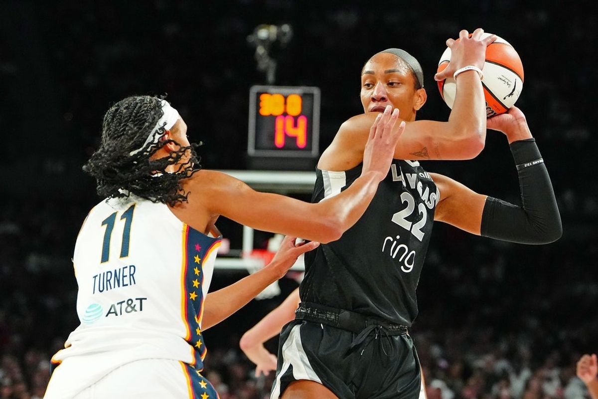 Sep 30, 2025; Las Vegas, Nevada, USA; Las Vegas Aces center A'ja Wilson (22) keeps the ball away from Indiana Fever forward Brianna Turner (11) during the third quarter of game five of the second round for the 2025 WNBA Playoffs at Michelob Ultra Arena. Mandatory Credit: Stephen R. Sylvanie-Imagn Images