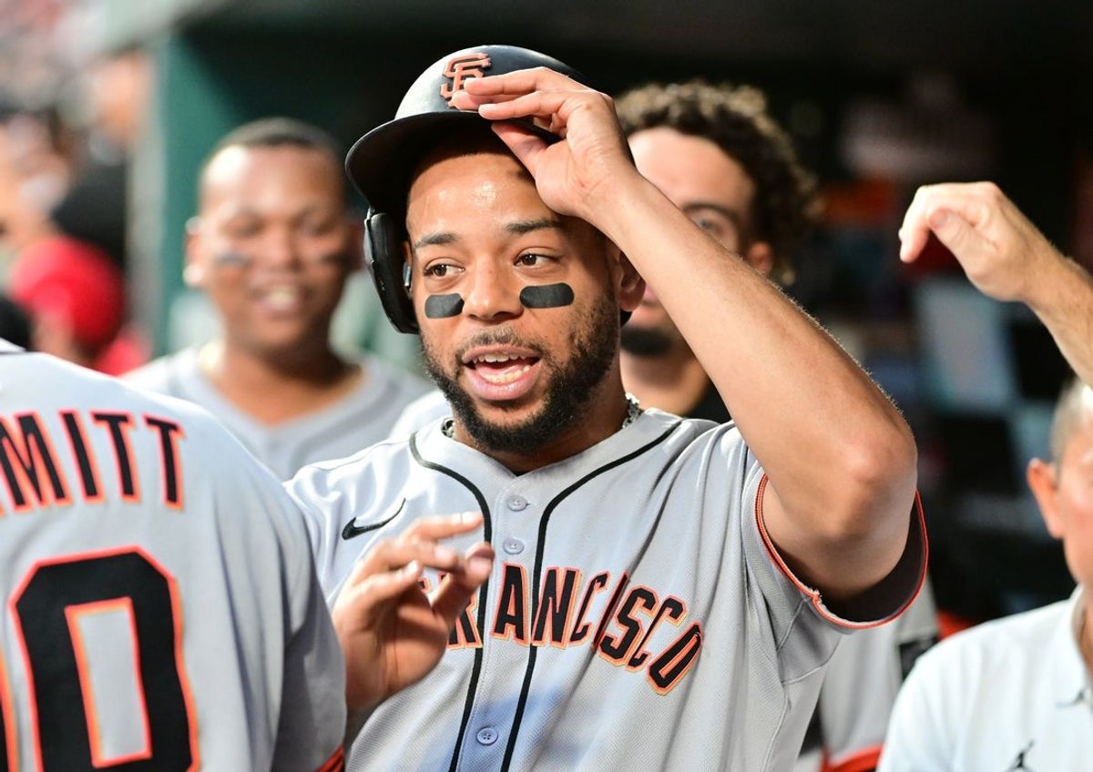 Sep 6, 2025; St. Louis, Missouri, USA;  San Francisco Giants designated hitter Dominic Smith (7) is congratulated in the dugout by teammates after scoring against the St. Louis Cardinals in the fourth inning at Busch Stadium. Mandatory Credit: Tim Vizer-Imagn Images