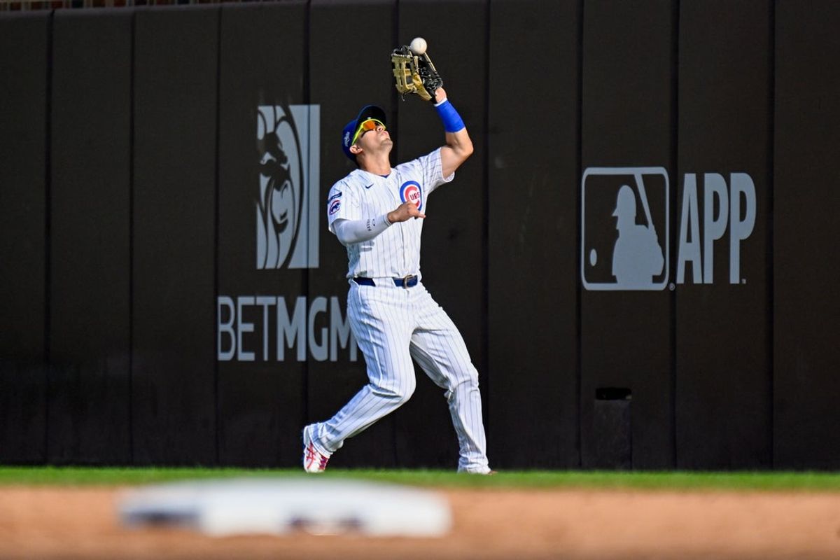 Oct 1, 2025; Chicago, Illinois, USA; Chicago Cubs outfielder Seiya Suzuki  (27) catches a fly ball for an out in the seventh inning against the San Diego Padres during game two of the Wildcard round for the 2025 MLB playoffs at Wrigley Field. Mandatory Credit: Matt Marton-Imagn Images