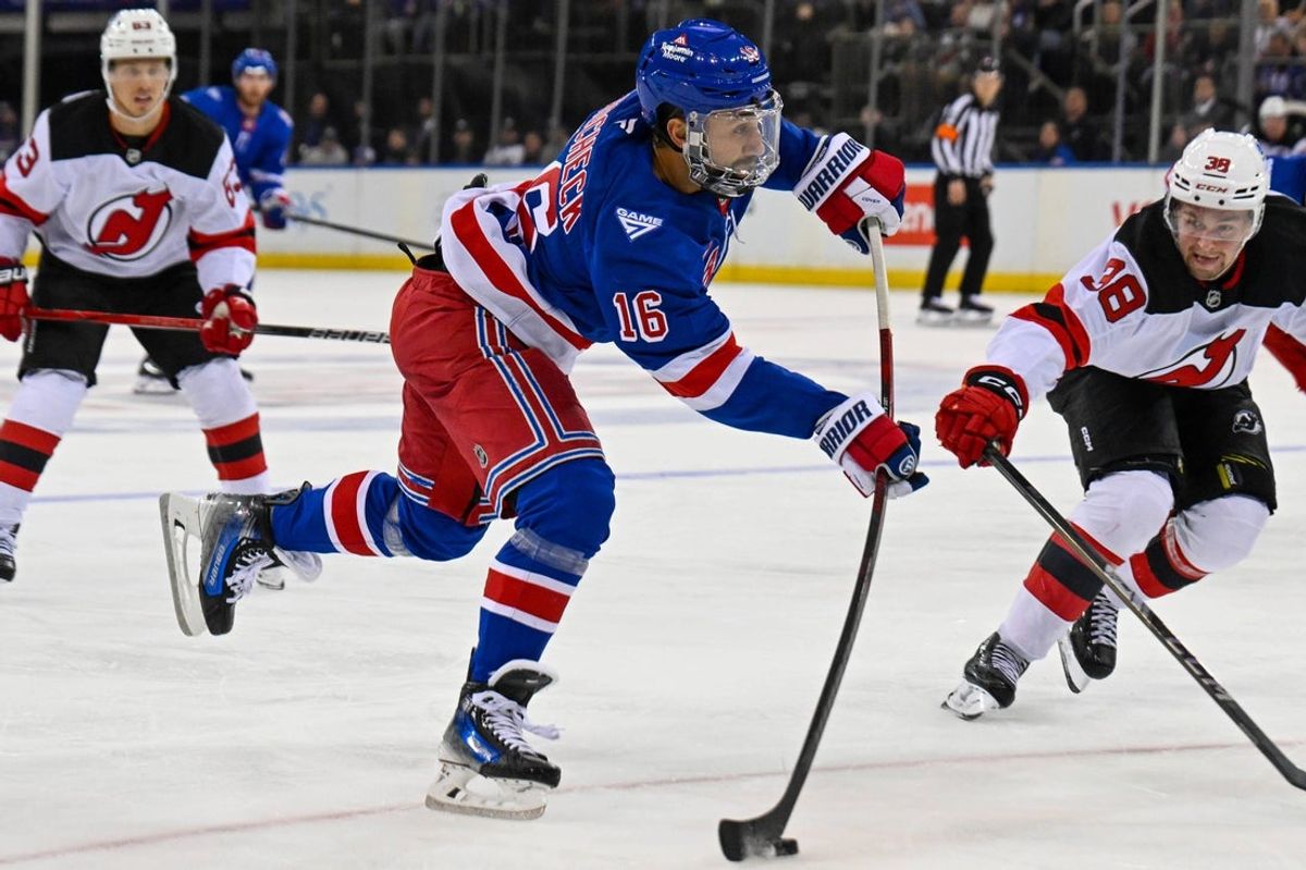 Oct 2, 2025; New York, New York, USA;  New York Rangers center Vincent Trocheck (16) attempts a shot defended by New Jersey Devils defenseman Topias Vilen (38) during the second period at Madison Square Garden. Mandatory Credit: Dennis Schneidler-Imagn Images