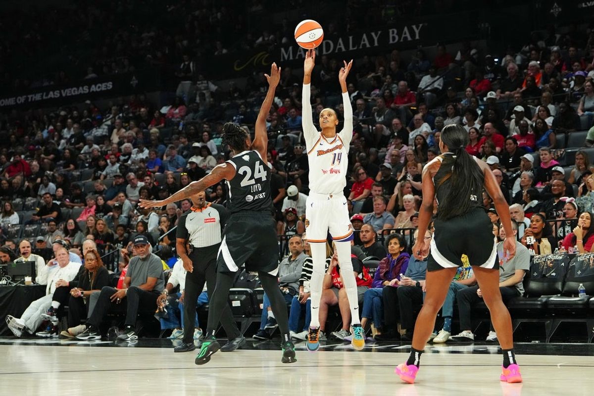 Oct 3, 2025; Las Vegas, Nevada, USA; Phoenix Mercury forward DeWanna Bonner (14) shoots against Las Vegas Aces guard Jewell Loyd (24) during the second quarter of game one of the 2025 WNBA Finals at Michelob Ultra Arena. Mandatory Credit: Stephen R. Sylvanie-Imagn Images