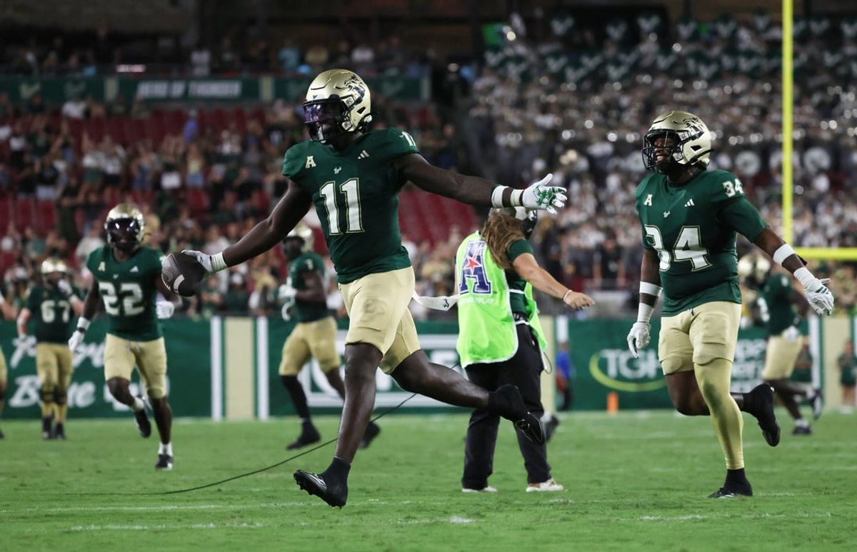 Oct 3, 2025; Tampa, Florida, USA;  South Florida Bulls defensive end D.J. Harris (11) celebrates after he intercepted the ball against the Charlotte 49ers during the second half at Raymond James Stadium. Mandatory Credit: Kim Klement Neitzel-Imagn Images