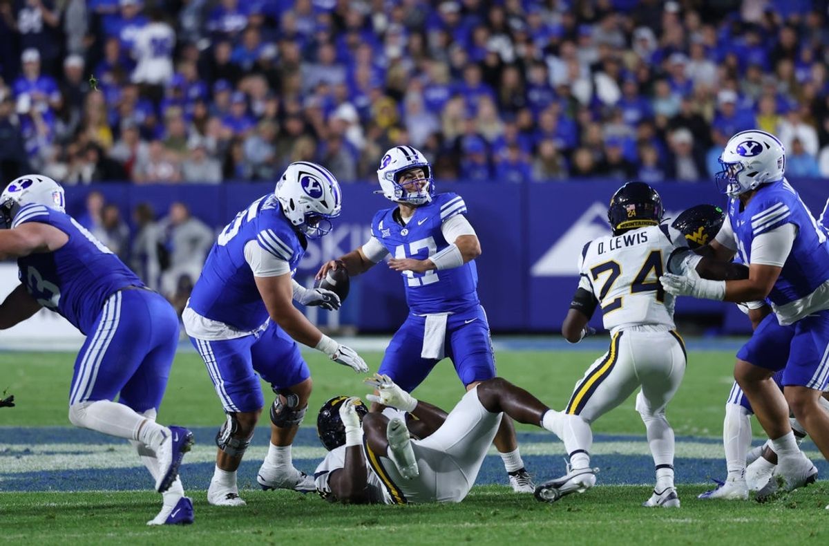 Oct 3, 2025; Provo, Utah, USA; Brigham Young Cougars quarterback Bear Bachmeier (47) throws the ball against the West Virginia Mountaineers during the second quarter at LaVell Edwards Stadium. Mandatory Credit: Rob Gray-Imagn Images