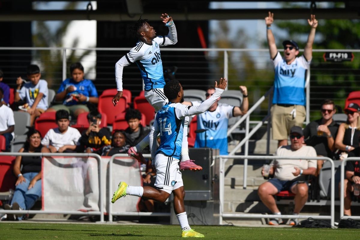 Oct 4, 2025; Washington, District of Columbia, USA; Charlotte FC forward Wilfried Zaha (10) celebrates after scoring a goal against the D.C. United with defender Nathan Byrne (14) during the first half of the game at Audi Field. Mandatory Credit: Hannah Foslien-Imagn Images