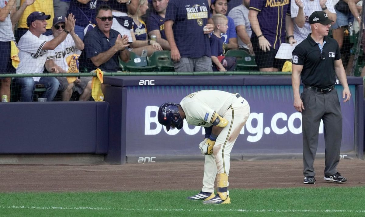 Milwaukee Brewers center fielder Jackson Chourio (11) bends over after a possible injury after hitting a single during the second inning of their National League Division Series game against the Chicago Cubs Saturday, October 4, 2025 at American Family Field in Milwaukee, Wisconsin.