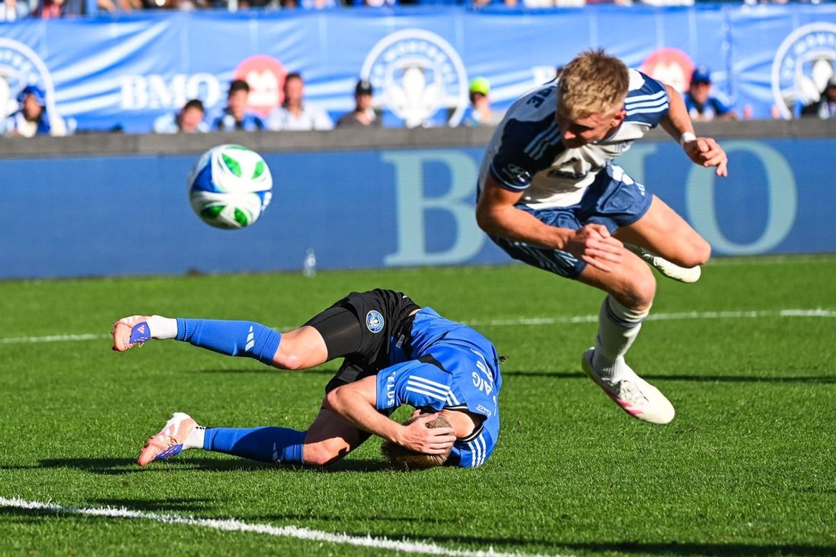 Oct 4, 2025; Montreal, Province of Quebec, CAN; CF Montreal defender Brandan Craig (5) rolls on the field after colliding with Nashville SC forward Sam Surridge (9) as he heads the ball for a boal during the second half at Saputo Stadium. Mandatory Credit: David Kirouac-Imagn Images