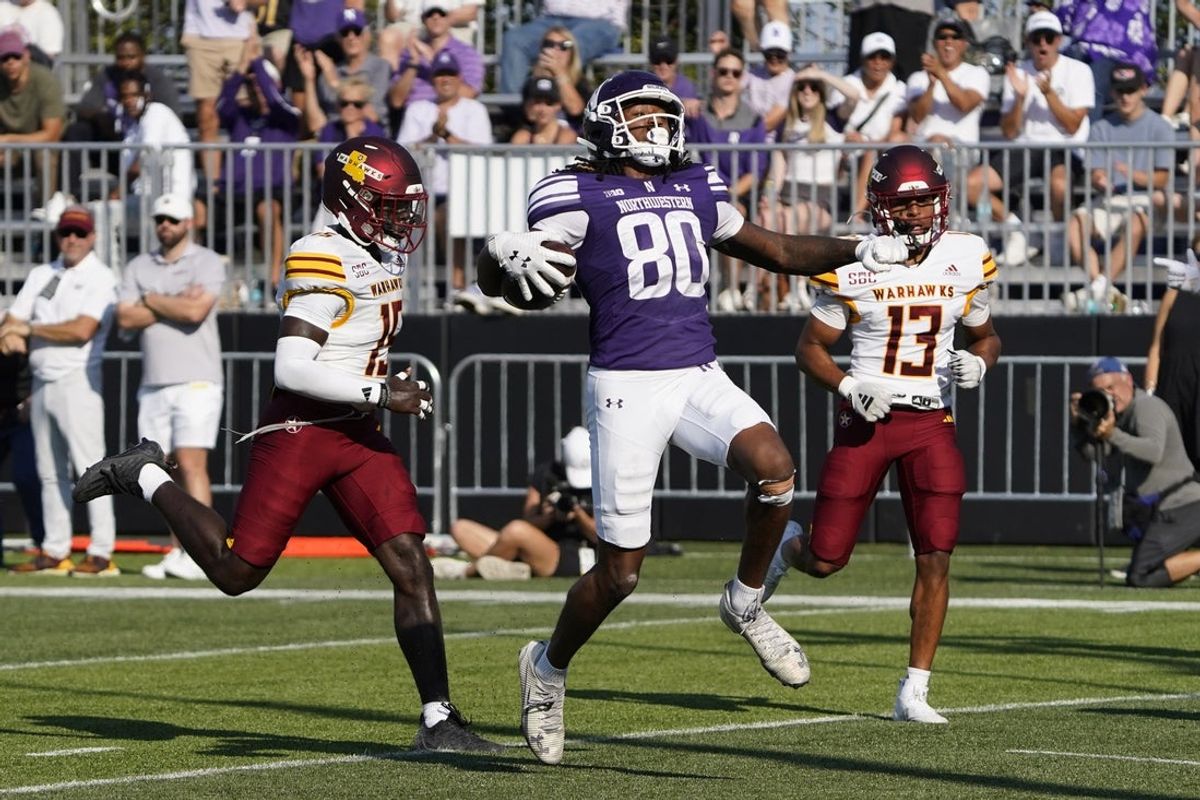 Oct 4, 2025; Evanston, Illinois, USA; Northwestern Wildcats wide receiver Hayden Eligon II (80) catches a touchdown pas as ULM Warhawks cornerback David Godsey Jr. (13) defends him during the first half at Northwestern Medicine Field at Martin Stadium. Mandatory Credit: David Banks-Imagn Images