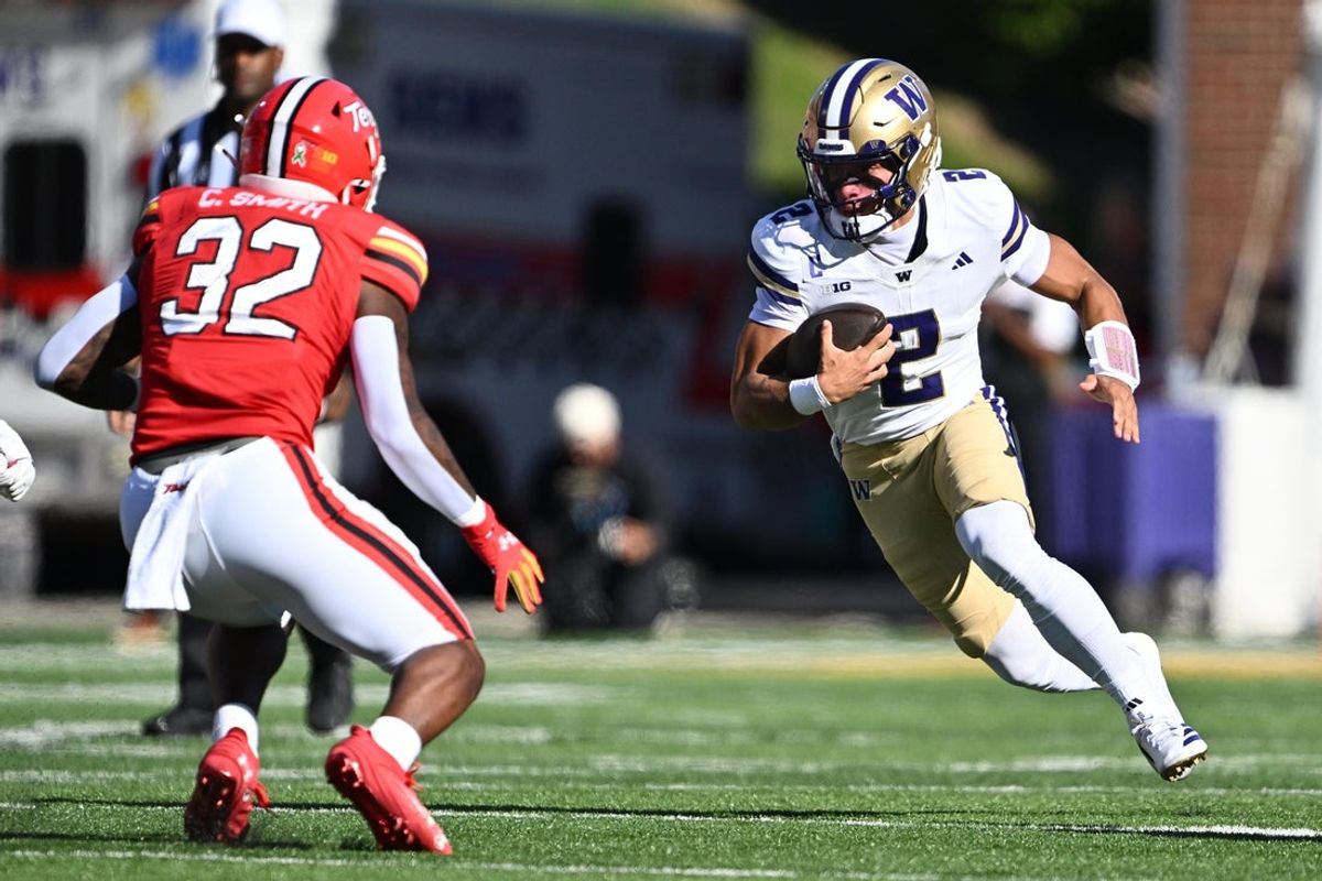 Oct 4, 2025; College Park, Maryland, USA;  Washington Huskies quarterback Demond Williams Jr. (2) looks for running room in the first half against the Maryland Terrapins at SECU Stadium. Mandatory Credit: Jamie Sabau-Imagn Images