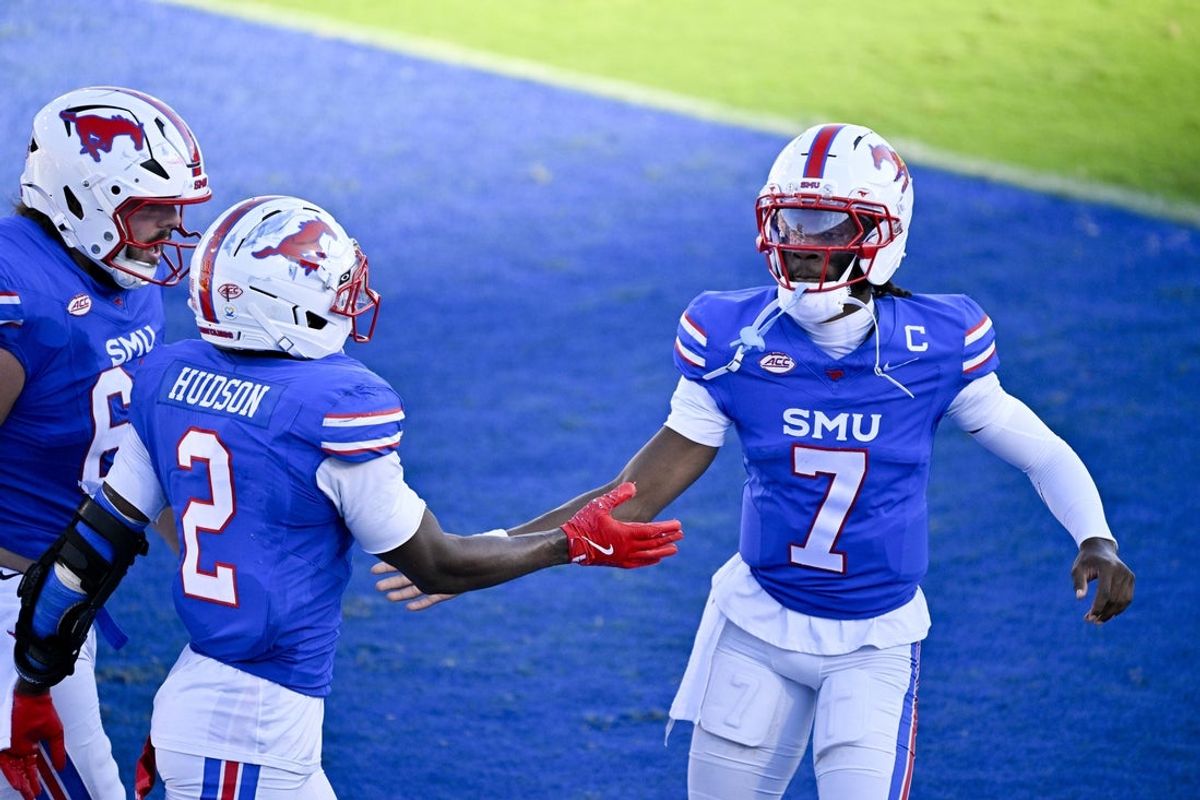 Oct 4, 2025; Dallas, Texas, USA; SMU Mustangs wide receiver Jordan Hudson (2) and quarterback Kevin Jennings (7) celebrate a touchdown against the Syracuse Orange during the second half at Gerald J. Ford Stadium. Mandatory Credit: Jerome Miron-Imagn Images