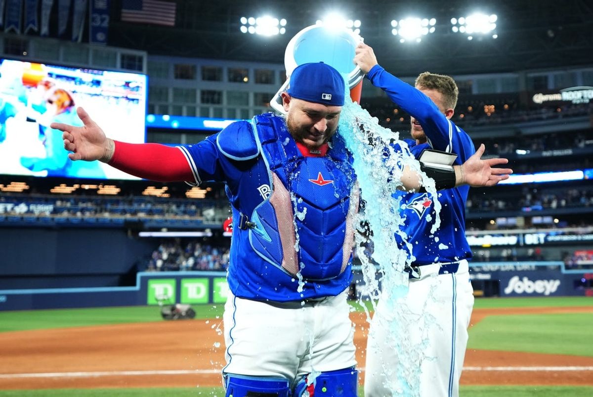 Oct 4, 2025; Toronto, Ontario, CAN; Toronto Blue Jays catcher Alejandro Kirk (30) is doused by catcher Tyler Heineman (55) after winning game one of the ALDS against the New York Yankees for the 2025 MLB playoffs at Rogers Centre. Mandatory Credit: Nick Turchiaro-Imagn Images