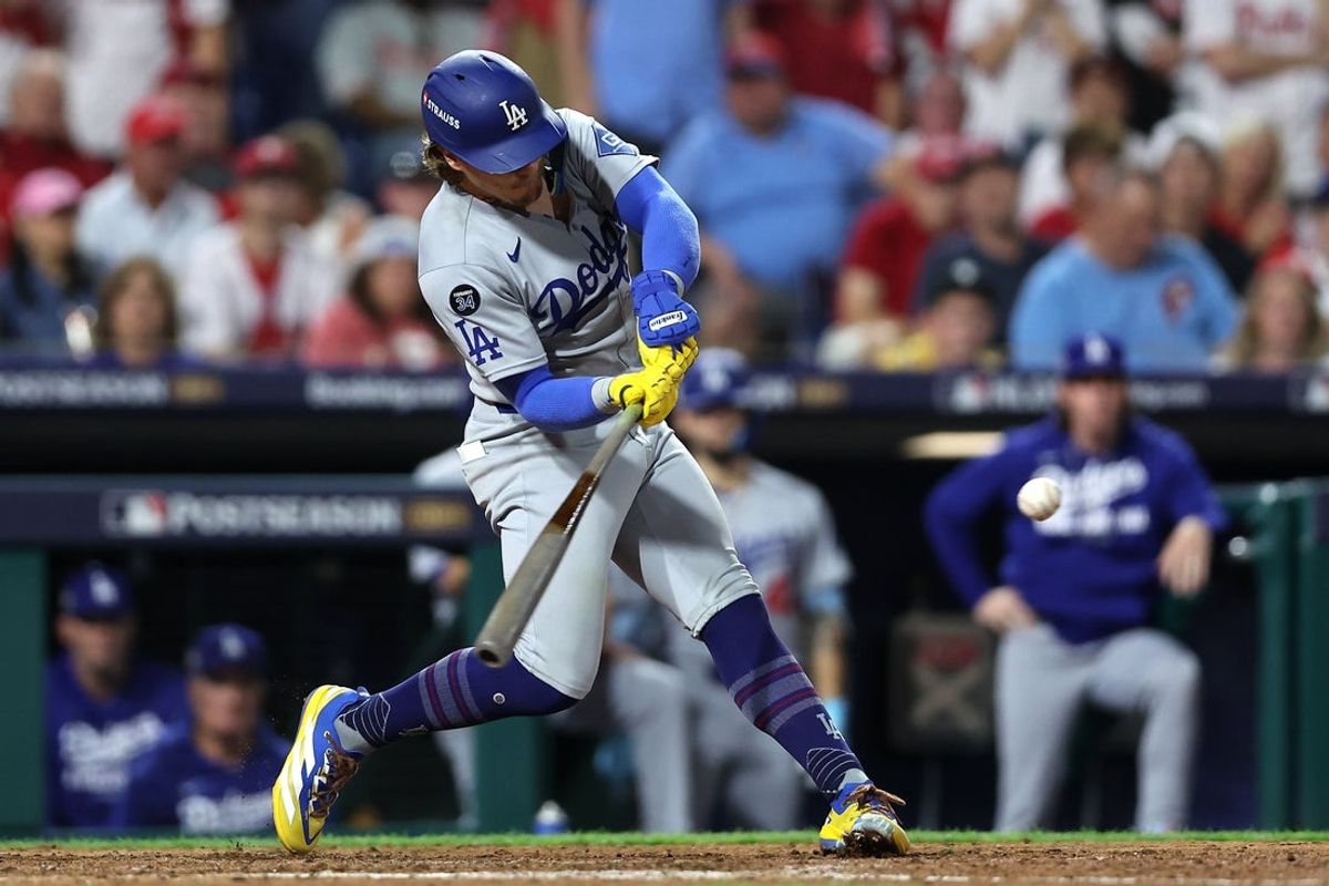Oct 4, 2025; Philadelphia, Pennsylvania, USA; Los Angeles Dodgers first baseman Enrique Hernandez (8) hits a two RBI double against the Philadelphia Phillies in the sixth inning during game one of the NLDS round for the 2025 MLB playoffs at Citizens Bank Park. Mandatory Credit: Bill Streicher-Imagn Images