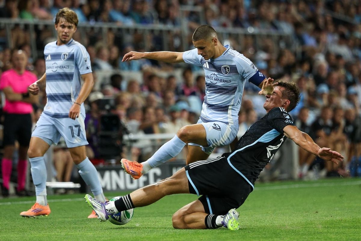 Oct 4, 2025; Saint Paul, Minnesota, USA; Sporting Kansas City forward Dejan Joveljic (9) and Minnesota United defender Morris Duggan (23) compete for the ball during the first half at Allianz Field. Mandatory Credit: Matt Krohn-Imagn Images