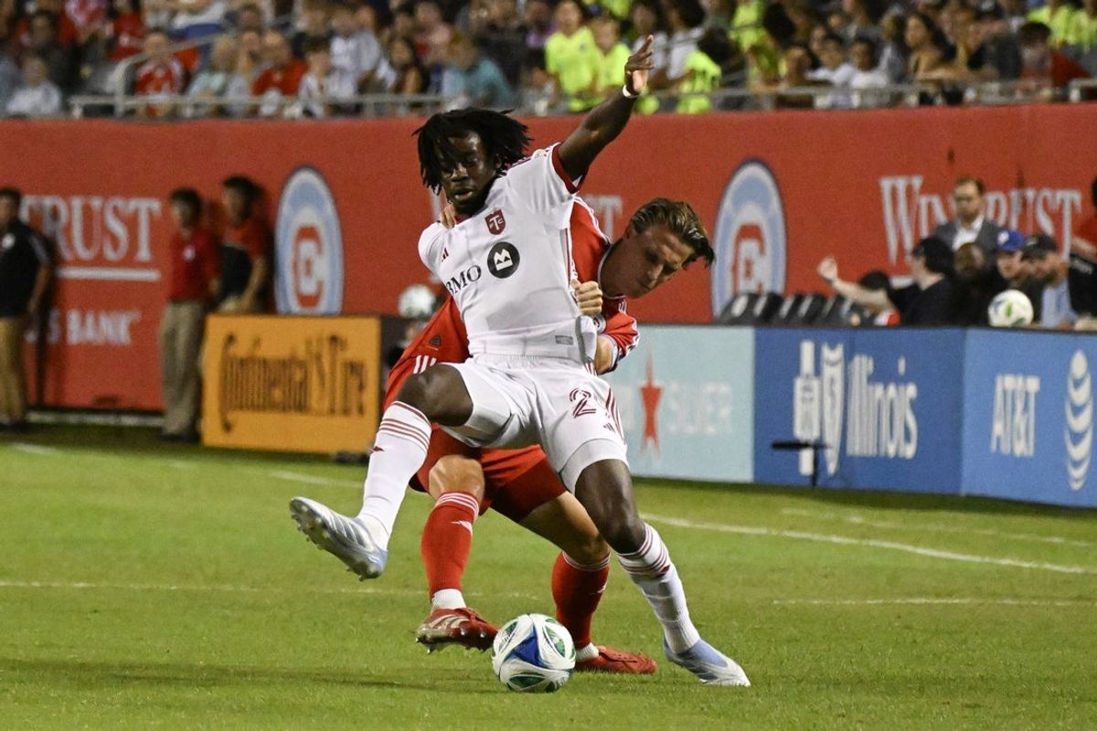 Oct 4, 2025; Chicago, Illinois, USA; Chicago Fire defender Jack Elliott (3) and Toronto forward Deandre Kerr (29) fight for the ball during the first half at Soldier Field. Mandatory Credit: Matt Marton-Imagn Images