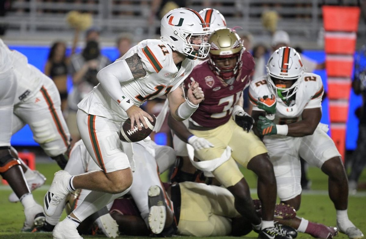 Oct 4, 2025; Tallahassee, Florida, USA; Miami Hurricanes quarterback Carson Beck (11) scrambles during the first half against the Florida State Seminoles at Doak S. Campbell Stadium. Mandatory Credit: Melina Myers-Imagn Images