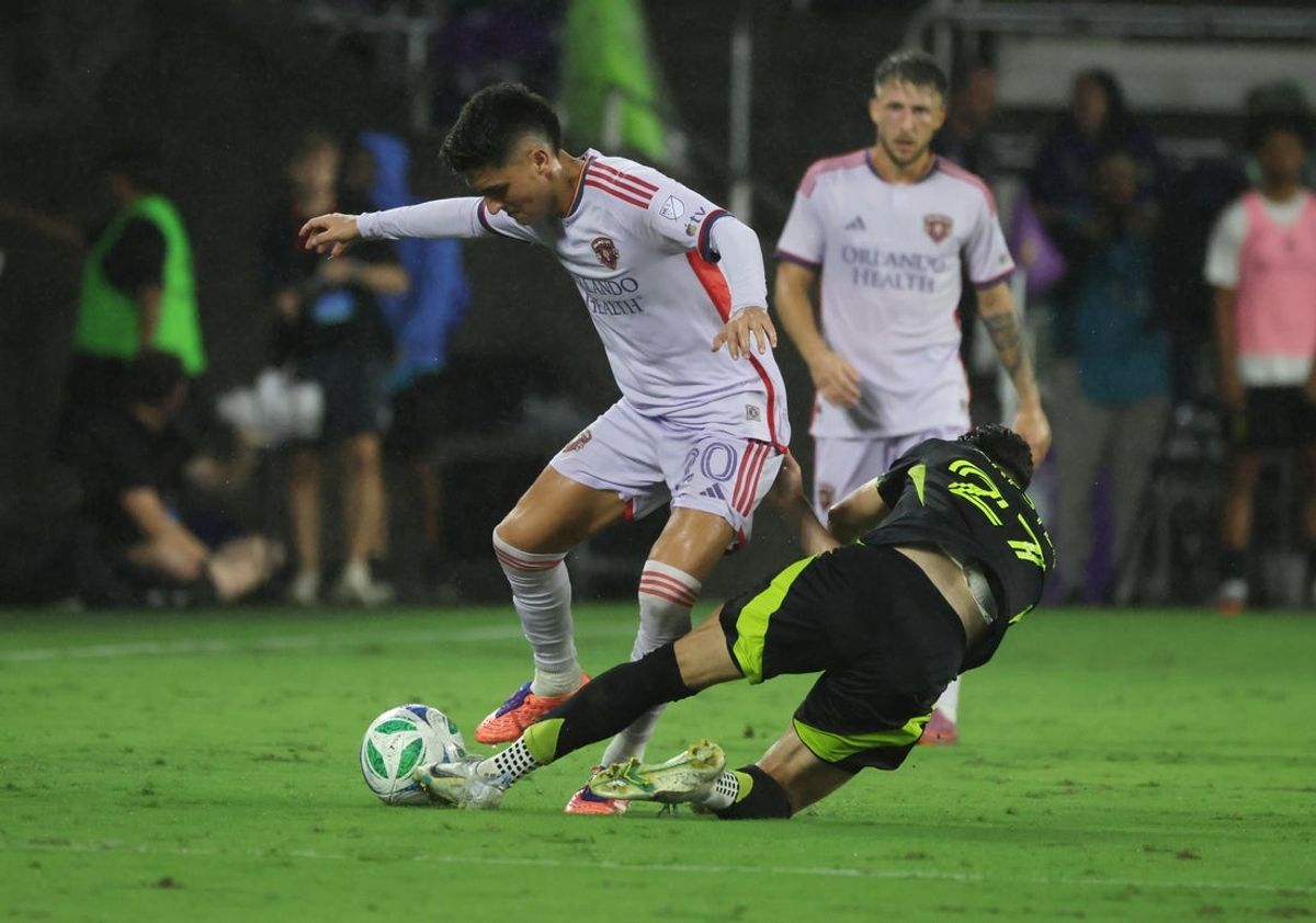 Oct 4, 2025; Orlando, Florida, USA; Columbus Crew forward Max Arfsten (27) defends Orlando City SC midfielder Eduard Atuesta (20) during the second half at Inter&Co Stadium. Mandatory Credit: Kim Klement Neitzel-Imagn Images