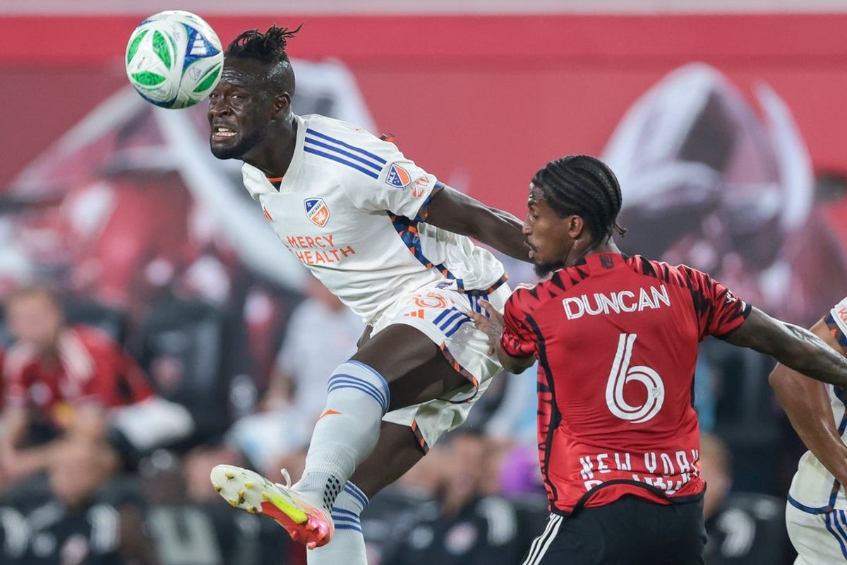Oct 4, 2025; Harrison, New Jersey, USA; FC Cincinnati forward Kei Kamara (85) heads the ball against New York Red Bulls defender Kyle Duncan (6) during the second half at Sports Illustrated Stadium. Mandatory Credit: Vincent Carchietta-Imagn Images