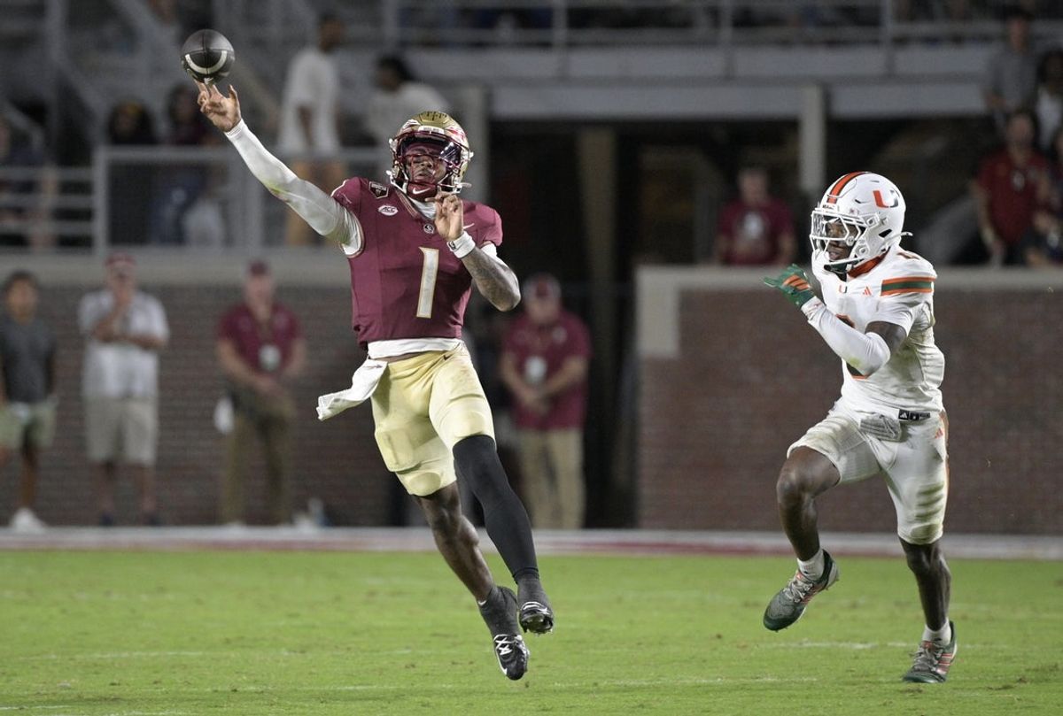 Oct 4, 2025; Tallahassee, Florida, USA; Florida State Seminoles quarterback Tommy Castellanos (1) throws against Miami Hurricanes defensive back Keionte Scott during the second half at Doak S. Campbell Stadium. Mandatory Credit: Melina Myers-Imagn Images
